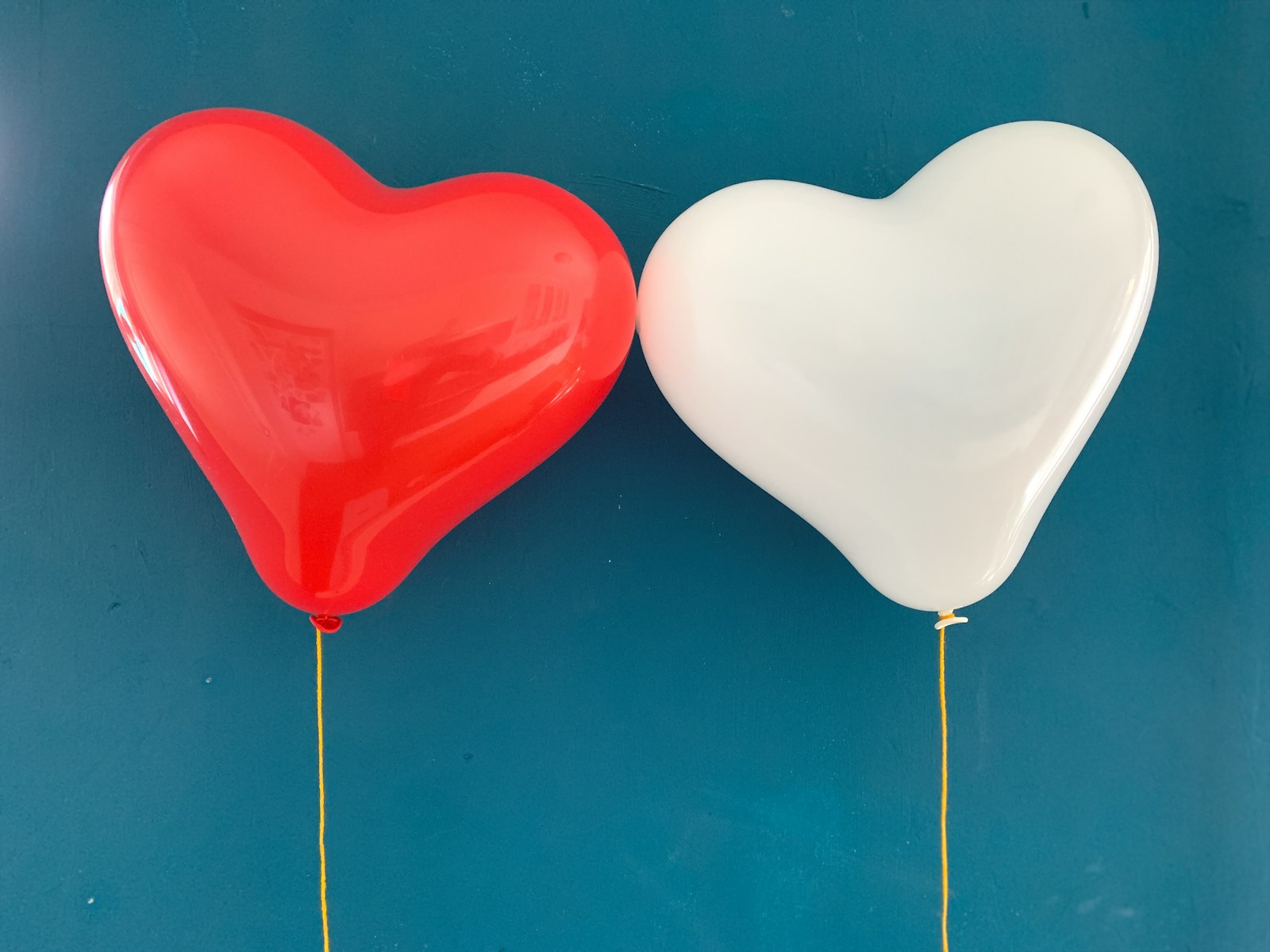 red heart balloon on blue surface